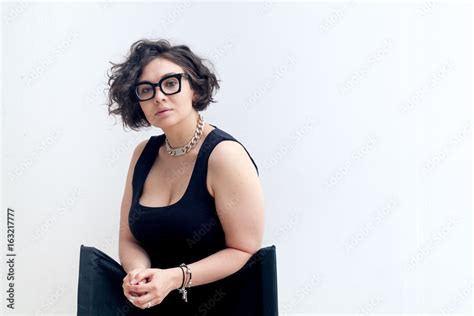 Portrait Of Young Plus Size Model With Dark Curvy Hair Wearing