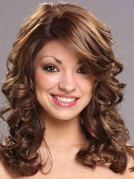 The effect is striking and youthful but still carries an air of confidence and doesn't require constant heat or product use. Medium length curly hairstyles with bangs