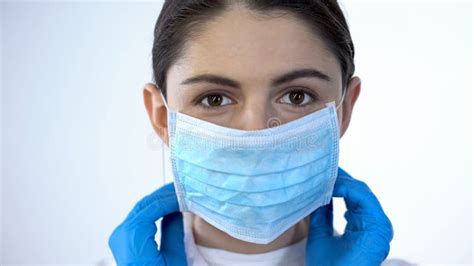Lady Doctor In Surgical Gloves Puts On Mask Disease Prevention