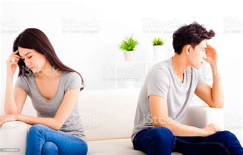 Young Couple Not Talking After Fight In Living Room Stock Photo