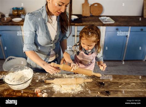 Mother Explaining How To Use Rolling Pin Making Bakery Stock Photo Alamy
