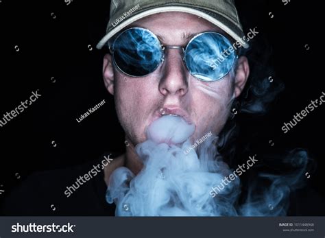 Male Model Blowing Out Some Smoke Stock Photo 1011448948 Shutterstock