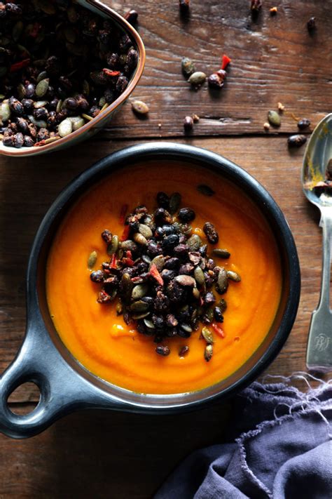 Carrot Pumpkin And Turmeric Soup With Spicy Black Bean Topping