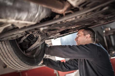 Auto Master Mechanic Checks Condition Of The Brakes And Wheels Stock