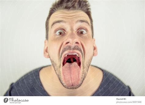 Man Looks Crazy Into The Camera With Open Mouth A Royalty Free Stock