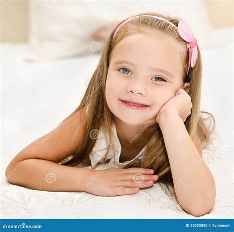 Smiling Little Girl Resting On The Bed Stock Photo Image Of
