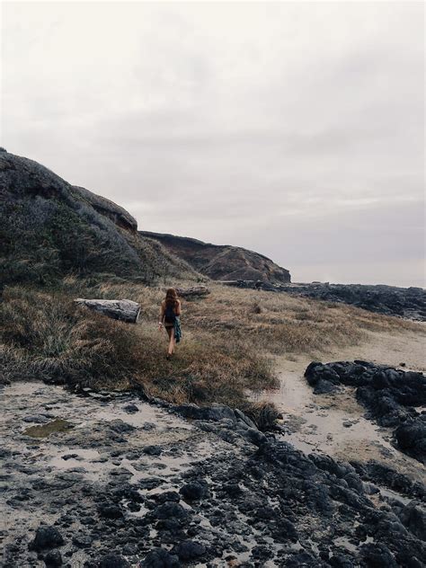 Woman Exploring Rugged Coastline Del Colaborador De Stocksy Kevin