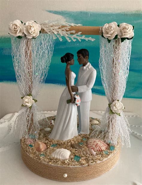 A Bride And Groom On Their Wedding Day In Front Of A Beach Scene Cake