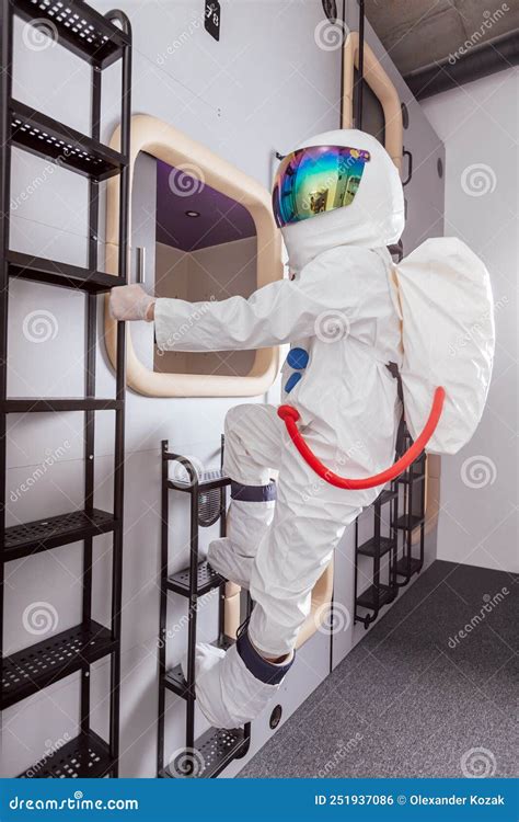 Astronauts Goes To His Sleeping Place In Capsule Hotel Stock Photo