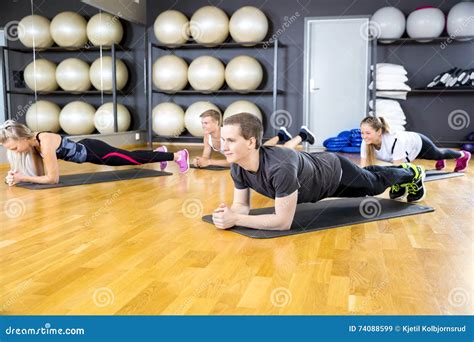 Group Of People Doing Plank At The Fitness Gym Class Stock Image