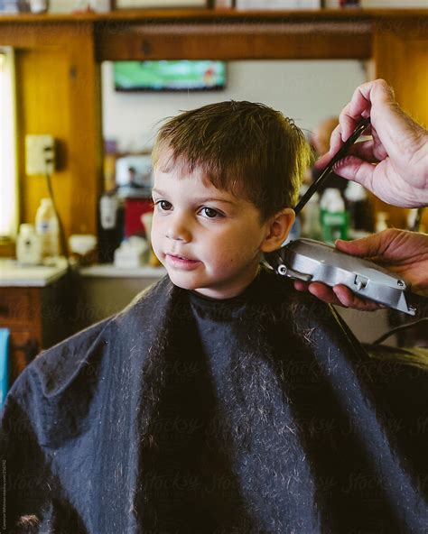 View "Handsome Young Boy Getting His Haircut In A Barbershop" by