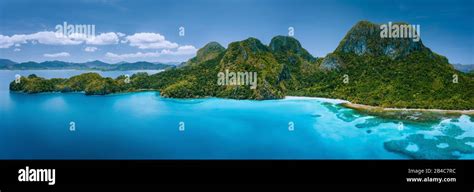 Aerial Drone View Of Uninhabited Tropical Island With Rugged Mountains