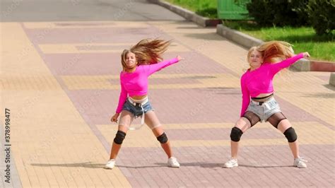 Two Cheerful Young Girls In Short Shorts Dancing Dancehall With