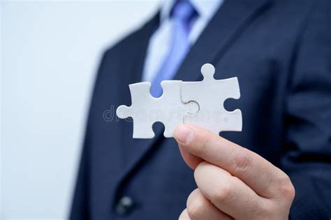 Businessman Showing A Jigsaw Puzzle Piece Business And Teamwork