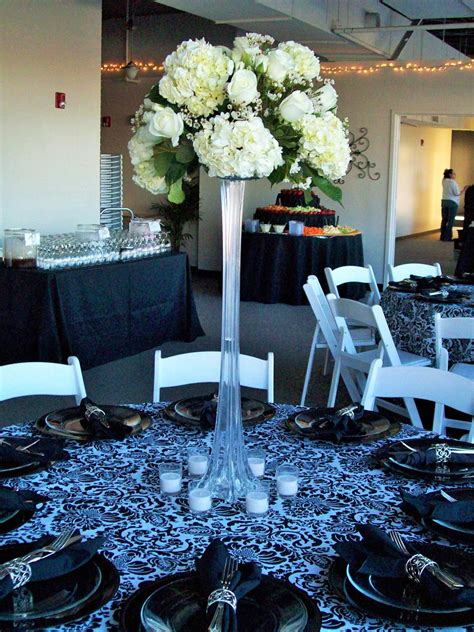 Tall Glass Vase Wedding Centerpiece With White Hydrangeas Surrounded By