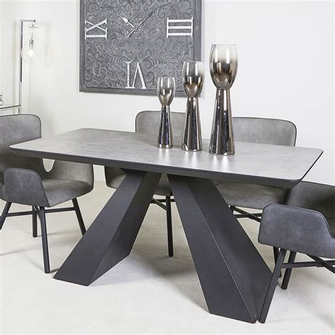 A round dining table can create a statement piece that anchors the room, especially when used in a more open floor plan. Axel Dining Table With Black Wooden Base And Grey Wood ...