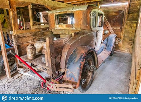 rusted vintage ford model a pickup truck in a barn editorial image