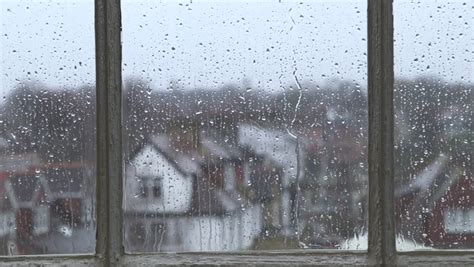 Heavy Rain Falling Against Large Window Pane Raindrops