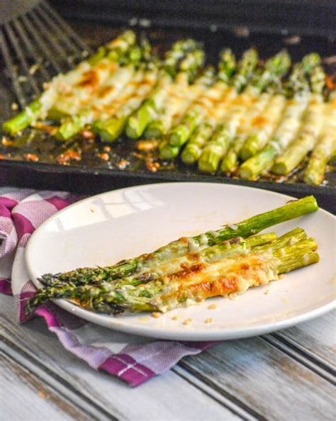 Place asparagus on a lipped roasting pan and toss with infused olive oil and garlic, coating all pieces. Garlic Roasted Cheesy Sheet Pan Asparagus - 4 Sons 'R' Us ...