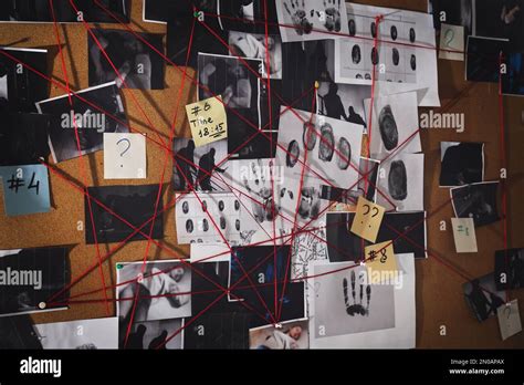 Detective board with fingerprints, crime scene photos and red threads