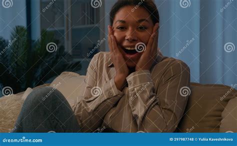 Surprised Shocked Happy African American Woman Ethnic Girl Homeowner On Couch At Evening Night