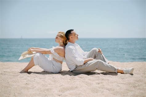 Lovers Siting Looking Into Sky And Ocean Mountion Under Sun Vacation Touris Stock Image