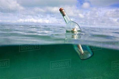 Message In A Bottle Floating In Ocean Stock Photo Dissolve