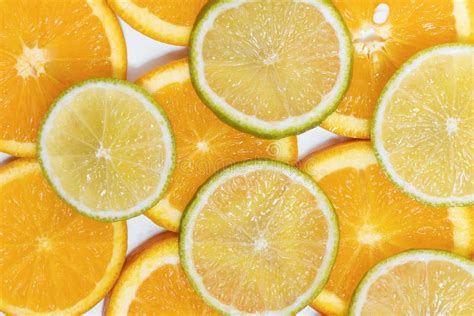 Round Slices Of Juicy Orange And Lime Background For Your Design Stock