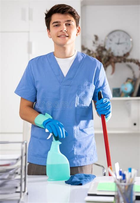 Portrait Of Positive Male Cleaner In Protective Uniform At Company