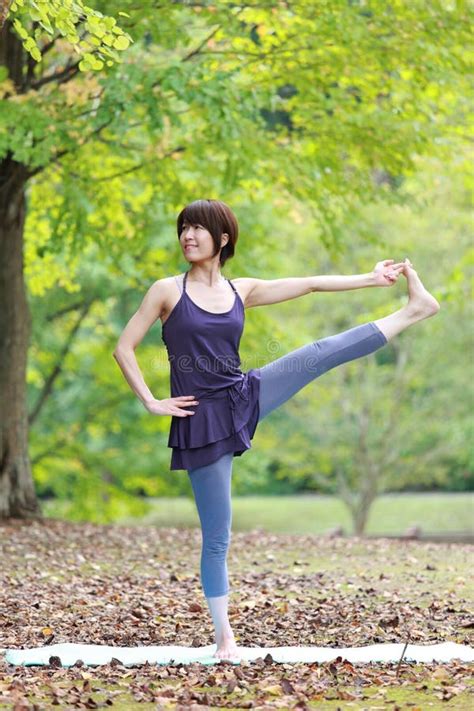 Japanese Woman Doing Yoga Extended Hand To Big Toe Pose Stock Photo