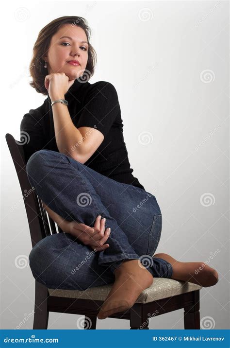 Portrait Of An Attractive Young Woman Sitting On A Chair Stock Image