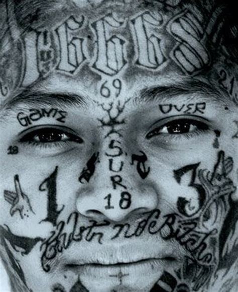 A Man With Lots Of Tattoos On His Face