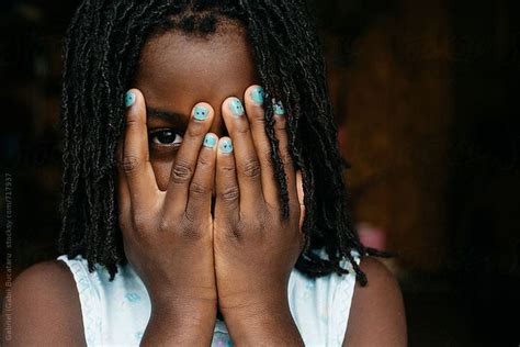 View African American Girl Peeking Behind Her Hands By Stocksy
