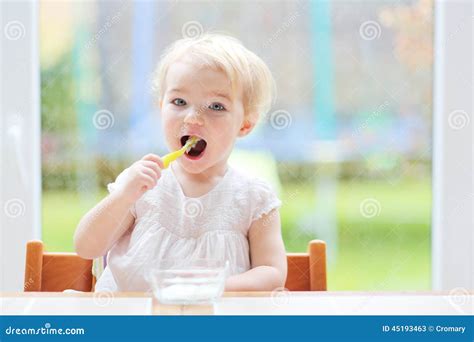 Cute Baby Girl Eating Yogurt From Spoon Stock Image Image Of Eating