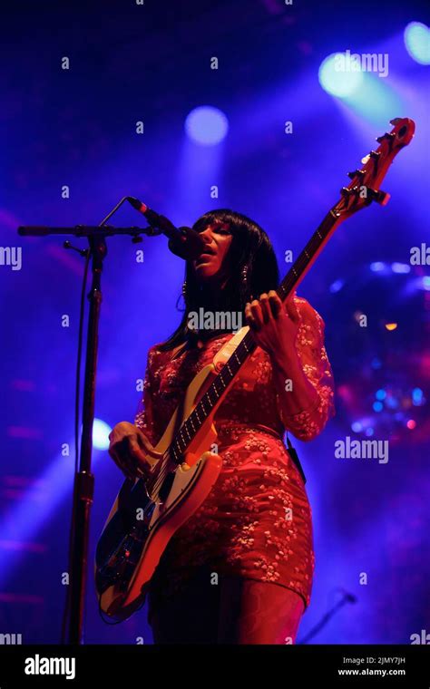 Bassist Laura Lee Of Khruangbin On Stage Wearing A Red Floral Mini