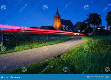 View Of A Medieval Church With Red Street Light With Long Exposure