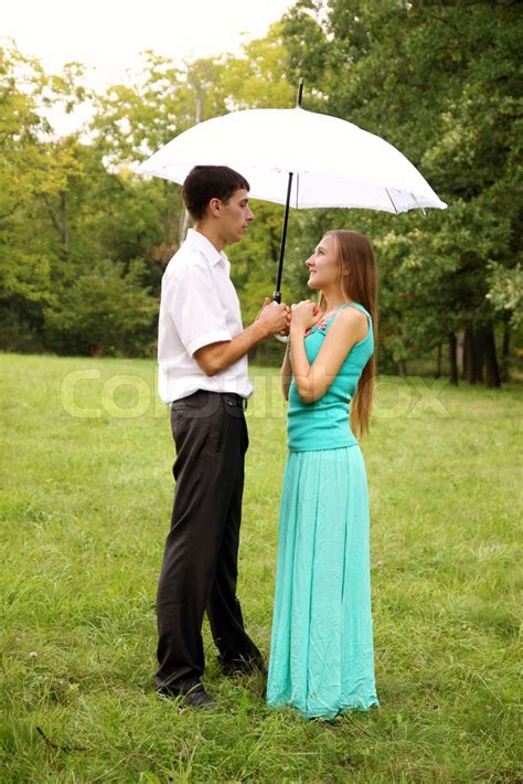 Loving Couple Standing Under A White Umbrella Stock Image Colourbox