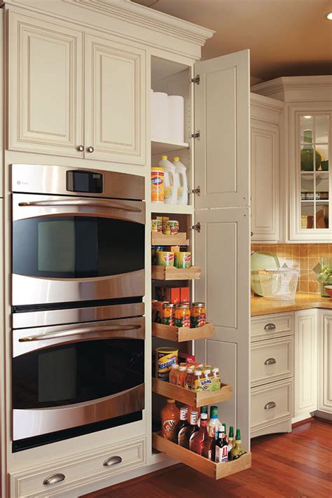 These drawers in a kitchen designed by krysta gibbons are outfitted with movable pegs, so they can accommodate various sized dishes as your needs and serveware collections change. Pullout Pantry Cabinet - Omega Cabinetry