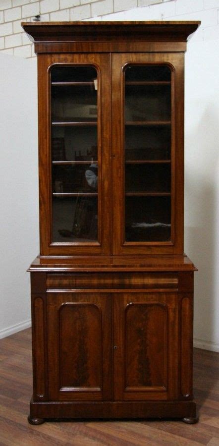 Pair of mahogany library bookcases, each with moulded cornice, above a pair of glazed panelled doors. A Victorian flame mahogany two door narrow bookcase having ...