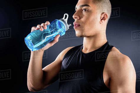 Handsome African American Sportsman Drinking Water On Black Stock