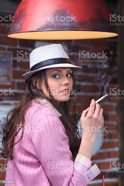 Profile Of Young Woman Smoking In A Bar Stock Photo Download Image