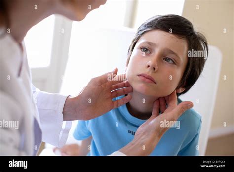 Doctor Examining The Lymph Nodes Of A 9 Year Old Boy Stock Photo Alamy