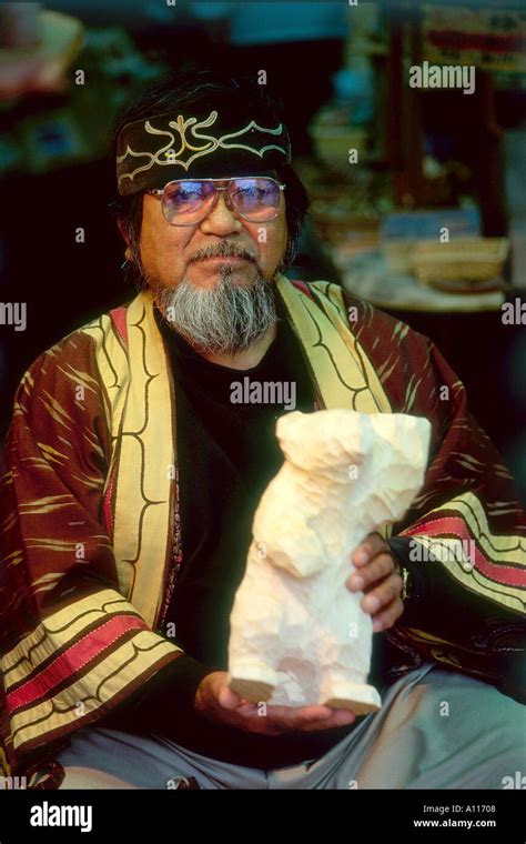 Old Ainu Man Showing Off His Hand Carved Bear In The Akan Kotan Village