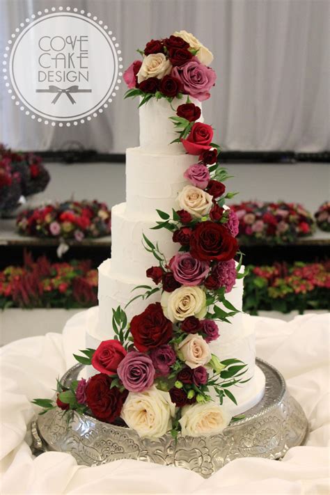 #monochromaticallycolorful #september #burgundy and gold #acoloramonth #burgundy and gold aesthetic. Rustic white iced wedding cake with fresh floral cascade ...