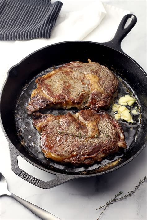 Heat the olive oil in a cast iron skillet until very hot. Cast iron pan with two steaks. in 2020 | Rib eye steak ...