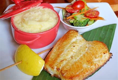 Premium Photo Plate Of Pan Seared Sea Bass With Salad And Mashed Potatoes