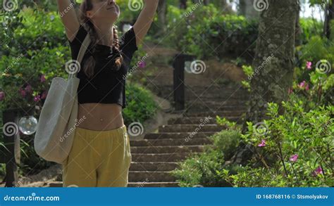 Slim Lady Stretches With Cheerful Smile Standing On Stairs Stock