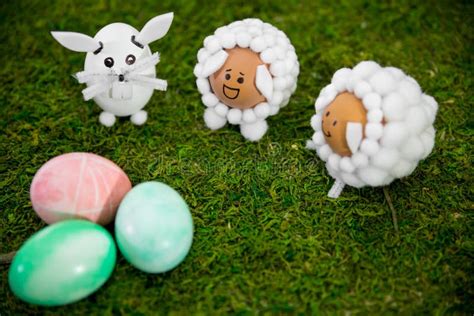 Cute Animal Shaped Eggs And Colorful Dyed Easter Eggs On Green Meadow