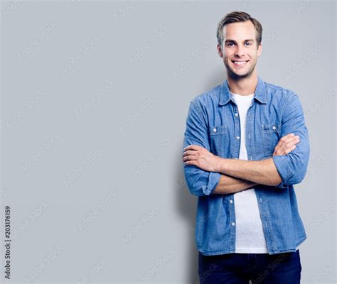 Portrait Of Young Man Standing In Crossed Arms Pose Stock 写真 Adobe Stock