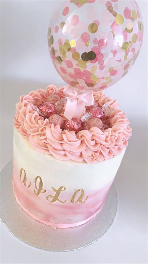 A Beautiful Blush Pink Buttercream Cake With Lindor Chocolate And A